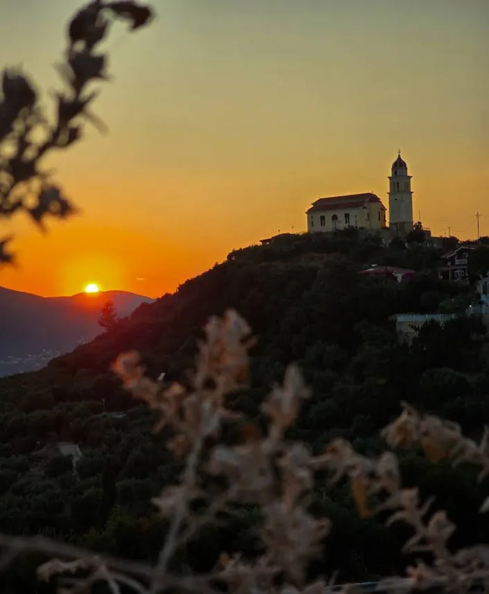 Sunset over the church on the hill, seen from Lofos Restaurant