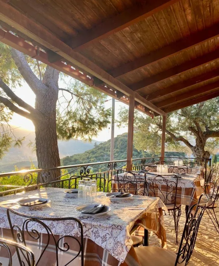 Tables set on the terrace with a view over the valley